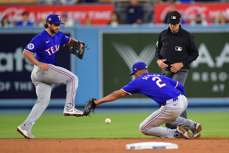 Jun 12, 2024; Los Angeles, California, USA; Texas Rangers second baseman Marcus Semien (2) is unable to field the single of Los Angeles Dodgers catcher Will Smith (16) during the ninth inning at Dodger Stadium. Mandatory Credit: Gary A. Vasquez-USA TODAY Sports