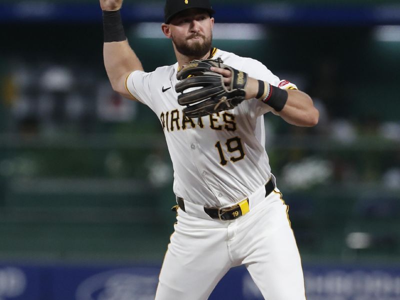 Aug 6, 2024; Pittsburgh, Pennsylvania, USA;  Pittsburgh Pirates second baseman Jared Triolo (19) throws to first base to complete a double play against the San Diego Padres during the first inning at PNC Park. Mandatory Credit: Charles LeClaire-USA TODAY Sports