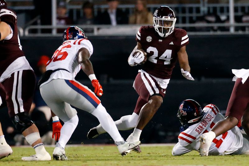 Nov 23, 2023; Starkville, Mississippi, USA; Mississippi State Bulldogs running back Keyvone Lee (24) runs the ball  during the first half against the Mississippi Rebels at Davis Wade Stadium at Scott Field. Mandatory Credit: Petre Thomas-USA TODAY Sports