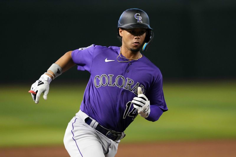 Sep 4, 2023; Phoenix, Arizona, USA; Colorado Rockies shortstop Ezequiel Tovar (14) scores a run against the Arizona Diamondbacks during the ninth inning at Chase Field. Mandatory Credit: Joe Camporeale-USA TODAY Sports