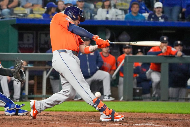 Apr 9, 2024; Kansas City, Missouri, USA; Houston Astros catcher Victor Caratini (17) is hit by a foul tip against the Kansas City Royals in the ninth inning at Kauffman Stadium. Mandatory Credit: Denny Medley-USA TODAY Sports