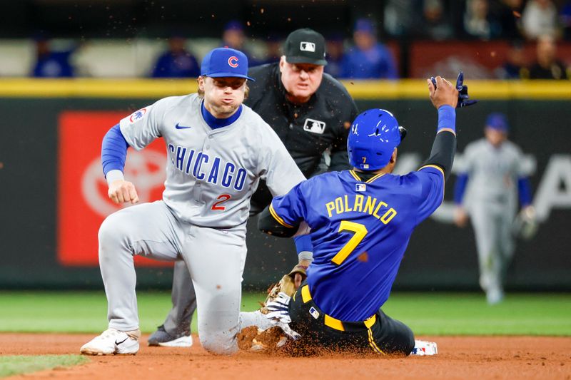 Apr 12, 2024; Seattle, Washington, USA; Chicago Cubs second baseman Nico Hoerner (2) tags out Seattle Mariners second baseman Jorge Polanco (7) on a stolen base attempt during the fifth inning at T-Mobile Park. Mandatory Credit: Joe Nicholson-USA TODAY Sports