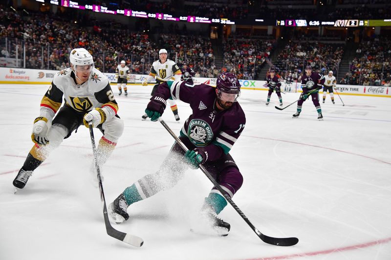 Dec 27, 2023; Anaheim, California, USA; Anaheim Ducks left wing Alex Killorn (17) moves the puck against Vegas Golden Knights defenseman Zach Whitecloud (2) during the third period at Honda Center. Mandatory Credit: Gary A. Vasquez-USA TODAY Sports