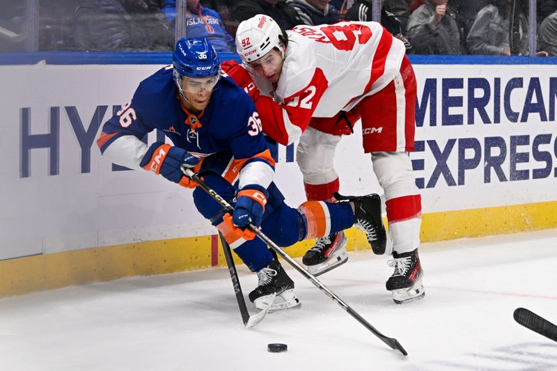 Nov 25, 2024; Elmont, New York, USA;  Detroit Red Wings center Marco Kasper (92) checks New York Islanders defenseman Isaiah George (36) during the third period at UBS Arena. Mandatory Credit: Dennis Schneidler-Imagn Images