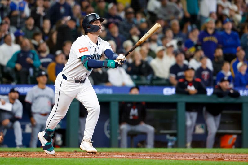 May 31, 2025; Seattle, Washington, USA; Seattle Mariners second baseman Cole Young (2) flies out during his first major league at bat during the second inning against the Minnesota Twins at T-Mobile Park. Minnesota Twins catcher Christian Vazquez (8) crouches at left. Mandatory Credit: Joe Nicholson-Imagn Images