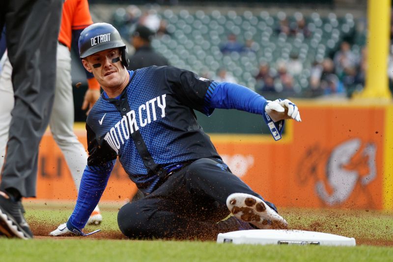 May 11, 2024; Detroit, Michigan, USA; Detroit Tigers outfielder Mark Canha (21) slides into third base against the Houston Astros during the first inning at Comerica Park. Mandatory Credit: Brian Bradshaw Sevald-USA TODAY Sports