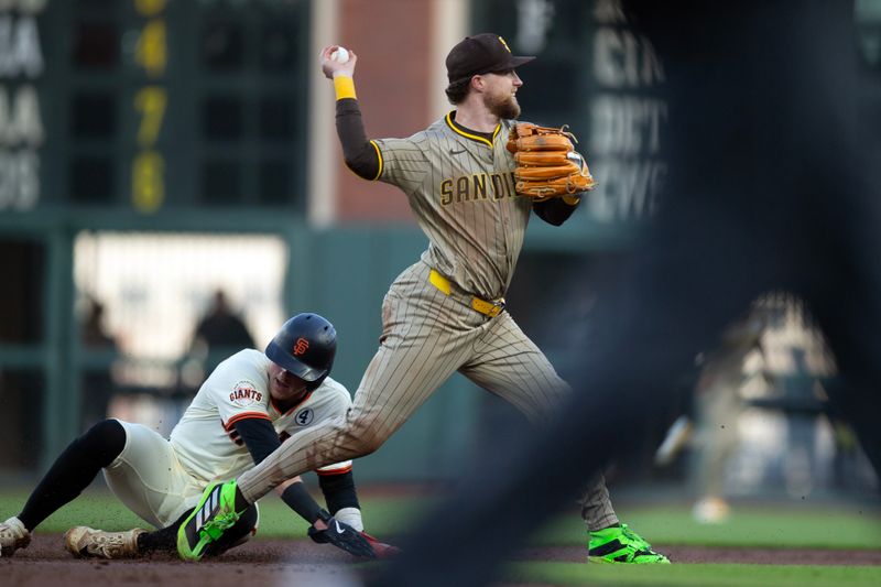 Jun 2, 2025; San Francisco, California, USA; San Diego Padres second baseman Jake Cronenworth (9) forces out San Francisco Giants second baseman Tyler Fitzgerald (49) to complete a double play during the second inning at Oracle Park. Mandatory Credit: D. Ross Cameron-Imagn Images
