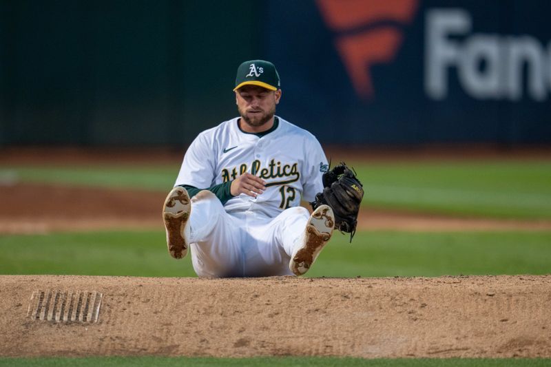 Aug 5, 2024; Oakland, California, USA;  Oakland Athletics shortstop Max Schuemann (12) after the catch against the Chicago White Sox during the sixth inning at Oakland-Alameda County Coliseum. Mandatory Credit: Neville E. Guard-USA TODAY Sports