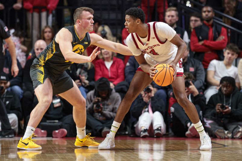 Feb 12, 2025; Piscataway, New Jersey, USA; Rutgers Scarlet Knights guard Ace Bailey (4) is guarded by Iowa Hawkeyes guard Carter Kingsbury (14) during the first half at Jersey Mike's Arena. Mandatory Credit: Vincent Carchietta-Imagn Images