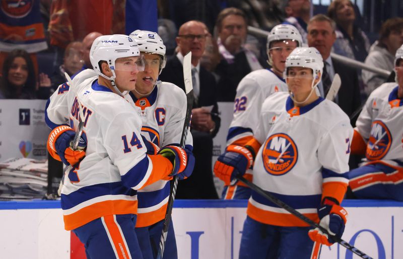 Nov 1, 2024; Buffalo, New York, USA;  New York Islanders center Bo Horvat (14) celebrates his goal with teammates during the first period against the Buffalo Sabres at KeyBank Center. Mandatory Credit: Timothy T. Ludwig-Imagn Images