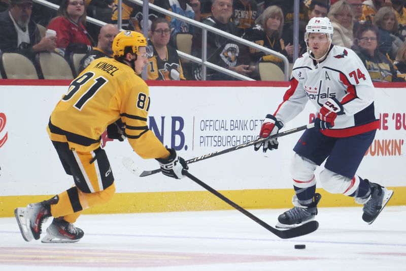 Nov 6, 2025; Pittsburgh, Pennsylvania, USA;  Pittsburgh Penguins center Ben Kindel (81)moves the puck against Washington Capitals defenseman John Carlson (74) during the second period at PPG Paints Arena. Mandatory Credit: Charles LeClaire-Imagn Images