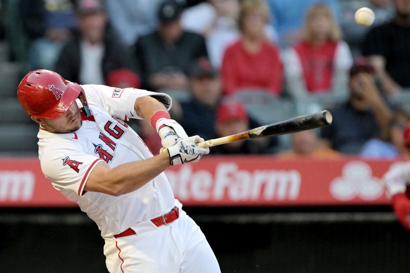 Apr 8, 2024; Anaheim, California, USA; Los Angeles Angels outfielder Mike Trout (27) hits a RBI triple in the first inning against the Tampa Bay Rays at Angel Stadium. Mandatory Credit: Jayne Kamin-Oncea-USA TODAY Sports