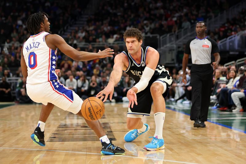 MILWAUKEE, WISCONSIN - MARCH 14: Brook Lopez #11 of the Milwaukee Bucks looks to pass around Tyrese Maxey #0 of the Philadelphia 76ers during the first half of a game at Fiserv Forum on March 14, 2024 in Milwaukee, Wisconsin. NOTE TO USER: User expressly acknowledges and agrees that, by downloading and or using this photograph, User is consenting to the terms and conditions of the Getty Images License Agreement. (Photo by Stacy Revere/Getty Images)