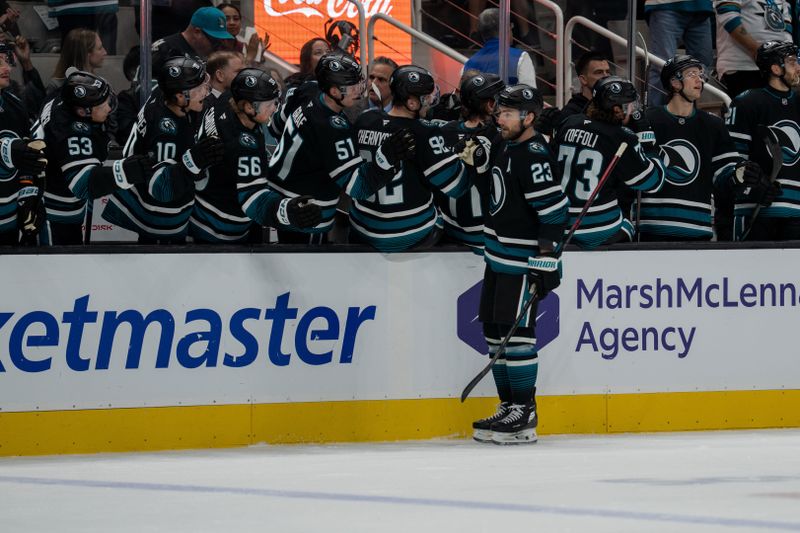 Dec 16, 2025; San Jose, California, USA; San Jose Sharks center Barclay Goodrow (23) celebrates with teammates after the goal against the Calgary Flames during the first period at SAP Center at San Jose. Mandatory Credit: Neville E. Guard-Imagn Images