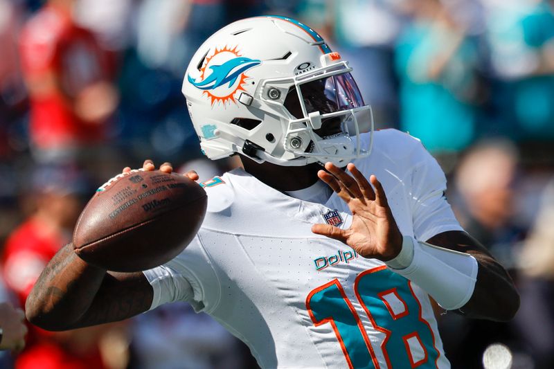 Miami Dolphins quarterback Tyler Huntley (18) makes a pass during warm-ups prior to an NFL football game against the New England Patriots on Sunday, Oct. 6, 2024, in Foxborough, Mass. (AP Photo/Greg M. Cooper)