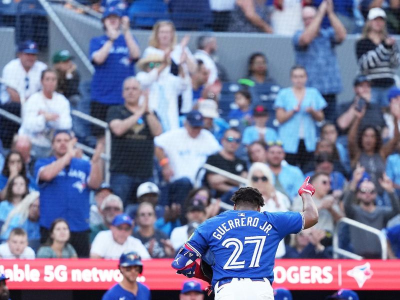 Sep 29, 2024; Toronto, Ontario, CAN; Toronto Blue Jays designated hitter Vladimir Guerrero Jr. (27) acknowledges the crowd as he walks towards the dugout against the Miami Marlins during the eighth inning at Rogers Centre. Mandatory Credit: Nick Turchiaro-Imagn Images