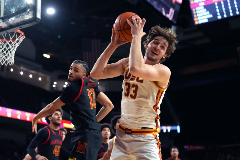 Jan 13, 2026; Los Angeles, California, USA; Southern California Trojans forward Jaden Brownell (33) rebounds the ball against Maryland Terrapins guard Isaiah Watts (12) in the second half at Galen Center. Mandatory Credit: Kirby Lee-Imagn Images