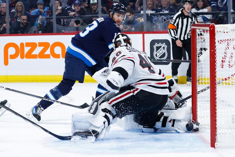 Oct 11, 2024; Winnipeg, Manitoba, CAN;  Chicago Blackhawks goalie Arvid Soderblom (40) makes a save on a shot by Winnipeg Jets forward Gabriel Vilardi (13) during the second period at Canada Life Centre. Mandatory Credit: Terrence Lee-Imagn Images