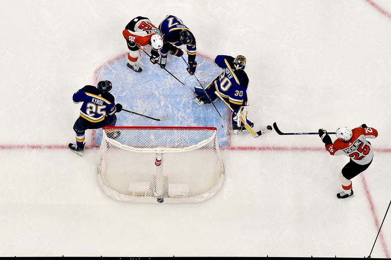 Jan 15, 2024; St. Louis, Missouri, USA;  Philadelphia Flyers center Ryan Poehling (25) defects the puck past St. Louis Blues goaltender Joel Hofer (30) for a goal during the second period at Enterprise Center. Mandatory Credit: Jeff Curry-USA TODAY Sports