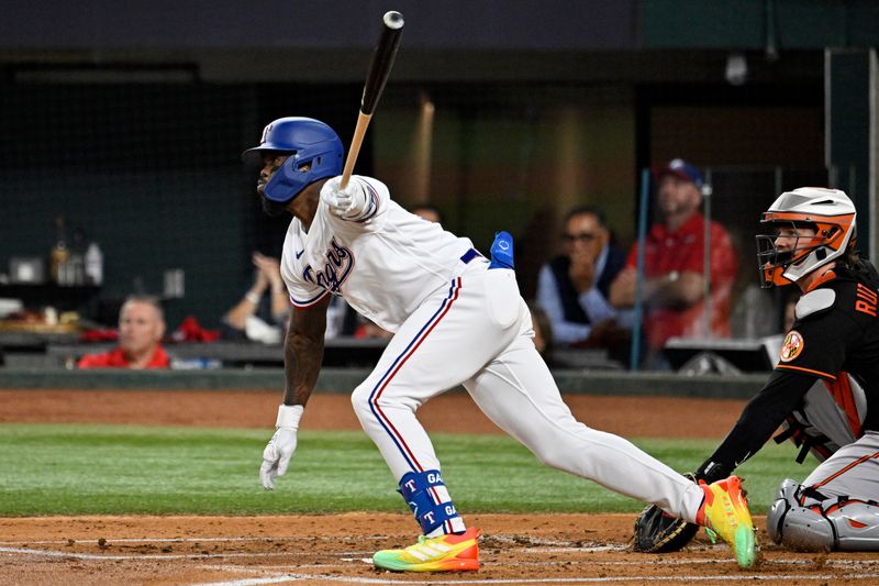 Oct 10, 2023; Arlington, Texas, USA; Texas Rangers right fielder Adolis Garcia (53) hits a single in the first inning against the Baltimore Orioles during game three of the ALDS for the 2023 MLB playoffs at Globe Life Field. Mandatory Credit: Jerome Miron-USA TODAY Sports