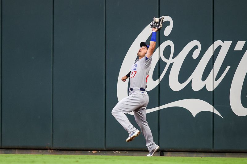 Sep 28, 2023; Atlanta, Georgia, USA; Chicago Cubs right fielder Seiya Suzuki (27) catches a fly ball against the Atlanta Braves in the second inning at Truist Park. Mandatory Credit: Brett Davis-USA TODAY Sports