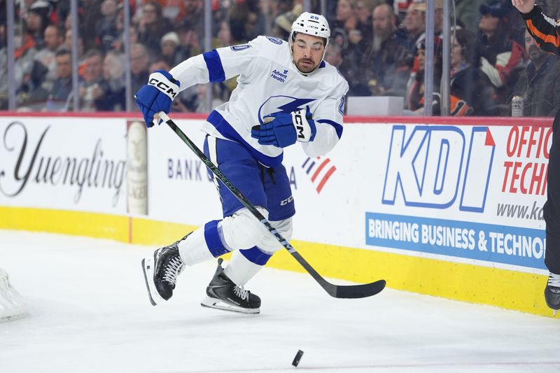 Jan 12, 2026; Philadelphia, Pennsylvania, USA; Tampa Bay Lightning left wing Nick Paul (20) reaches for the puck against the Philadelphia Flyers in the second period at Xfinity Mobile Arena. Mandatory Credit: Kyle Ross-Imagn Images