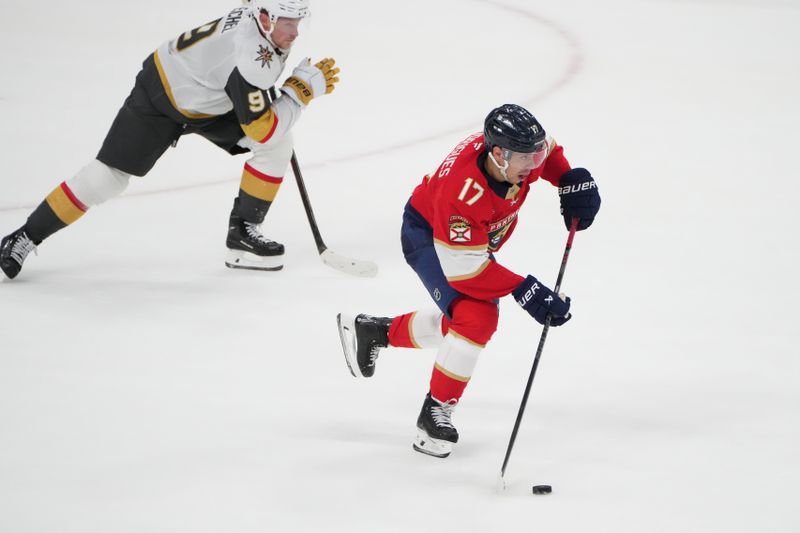 Oct 19, 2024; Sunrise, Florida, USA;  Florida Panthers center Evan Rodrigues (17) brings the puck up the ice against Vegas Golden Knights center Jack Eichel (9) in overtime at Amerant Bank Arena. Mandatory Credit: Jim Rassol-Imagn Images