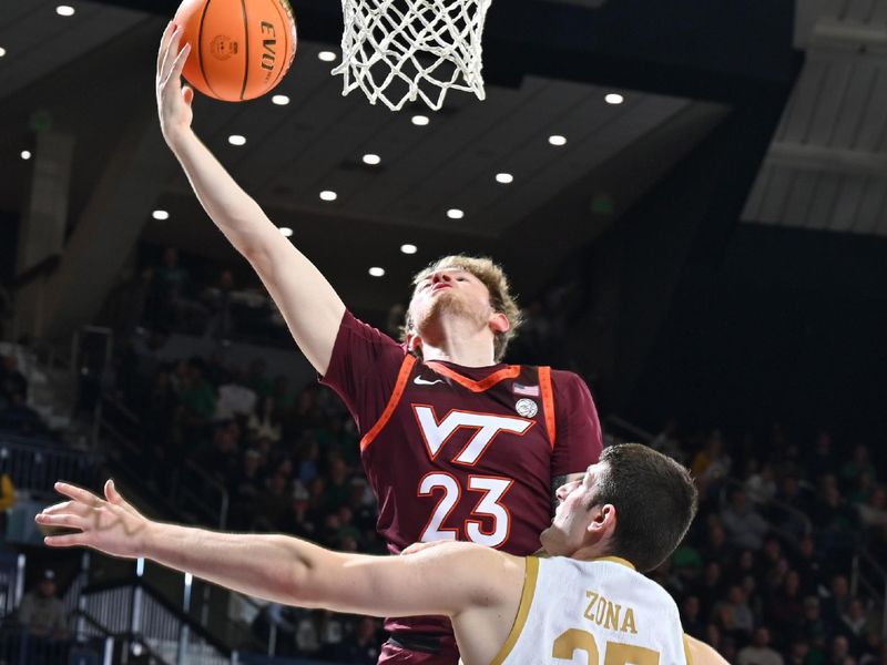 Feb 10, 2024; South Bend, Indiana, USA; Virginia Tech Hokies guard Tyler Nickel (23) is fouled by Notre Dame Fighting Irish forward Matt Zona (25) in the first half at the Purcell Pavilion. Mandatory Credit: Matt Cashore-USA TODAY Sports