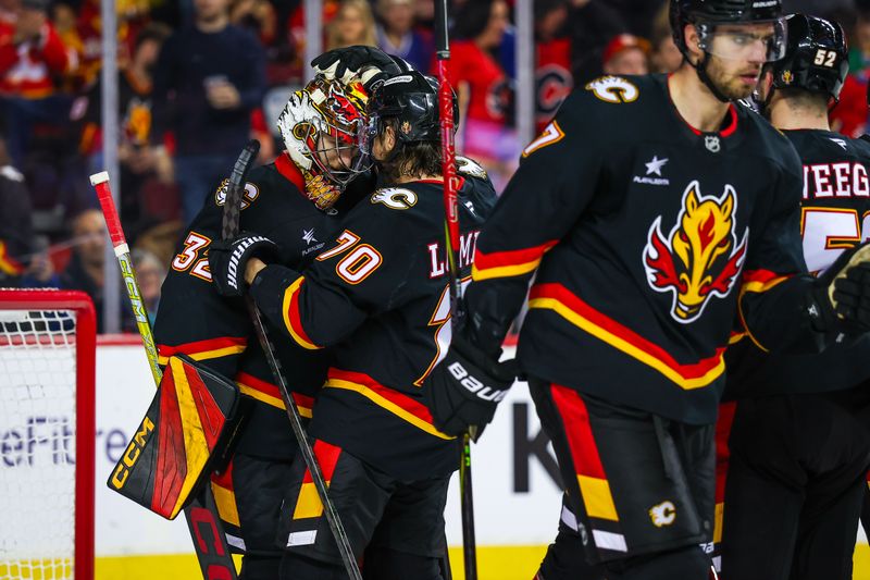 Dec 31, 2024; Calgary, Alberta, CAN; Calgary Flames goaltender Dustin Wolf (32) celebrate win with teammates after defeating Vancouver Canucks at Scotiabank Saddledome. Mandatory Credit: Sergei Belski-Imagn Images