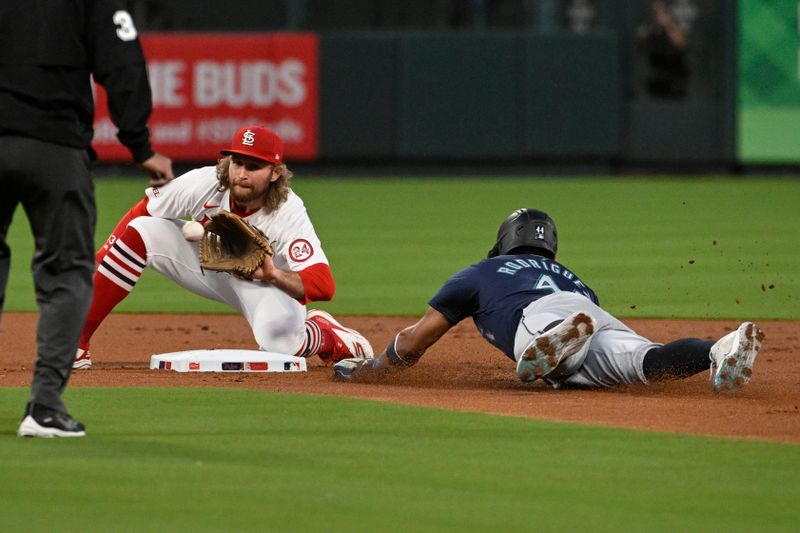 Sep 6, 2024; St. Louis, Missouri, USA; Seattle Mariners center fielder Julio Rodriguez (44) safely steals second base ahead of the tag from St. Louis Cardinals second baseman Brendan Donovan (33) in the first inning at Busch Stadium. Mandatory Credit: Joe Puetz-Imagn Images