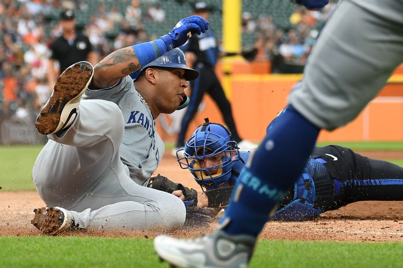 Aug 2, 2024; Detroit, Michigan, USA;  Kansas City Royals first baseman Salvador Perez (13) slides safely into home plate under the tag of Detroit Tigers catcher Jake Rogers (34) in the fourth inning at Comerica Park. Mandatory Credit: Lon Horwedel-USA TODAY Sports