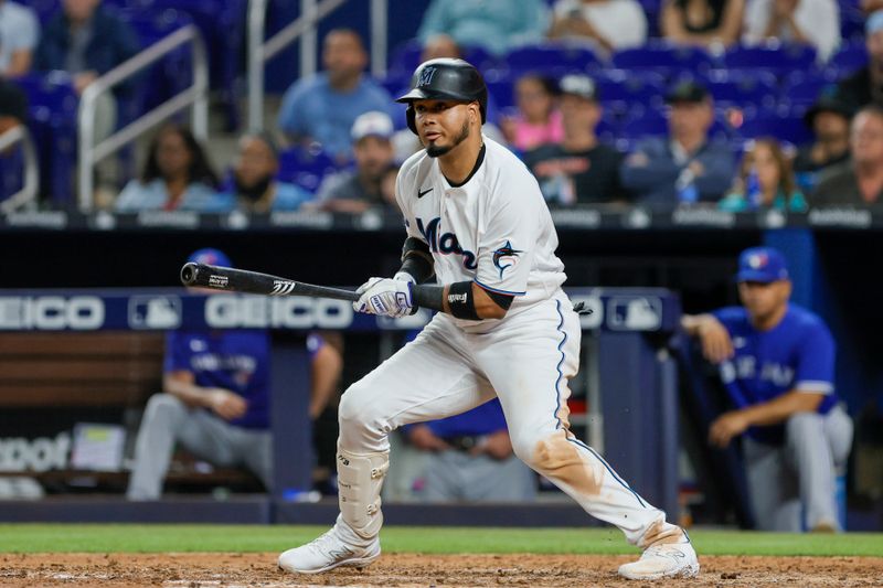 Jun 19, 2023; Miami, Florida, USA; Miami Marlins second baseman Luis Arraez (3) watches after hitting a single against the Toronto Blue Jays during the seventh inning at loanDepot Park. Mandatory Credit: Sam Navarro-USA TODAY Sports