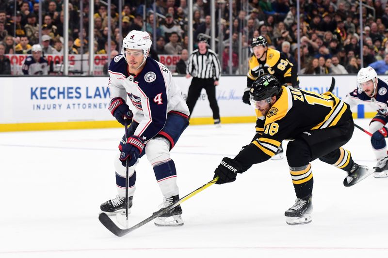 Nov 18, 2024; Boston, Massachusetts, USA;  Boston Bruins center Pavel Zacha (18) pokes the puck away from Columbus Blue Jackets center Cole Sillinger (4) during the second period at TD Garden. Mandatory Credit: Bob DeChiara-Imagn Images