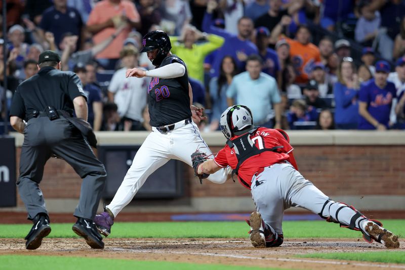 Sep 6, 2024; New York City, New York, USA; New York Mets first baseman Pete Alonso (20) scores a run ahead of a tag by Cincinnati Reds catcher Tyler Stephenson (37) on a double by Mets pinch hitter Jose Iglesias (not pictured) during the sixth inning at Citi Field. Mandatory Credit: Brad Penner-Imagn Images