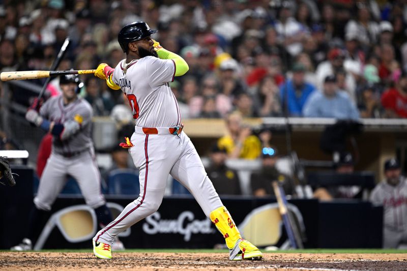 Jul 12, 2024; San Diego, California, USA; Atlanta Braves designated hitter Marcell Ozuna (20) hits a home run against the San Diego Padres during the ninth inning at Petco Park. Mandatory Credit: Orlando Ramirez-USA TODAY Sports 