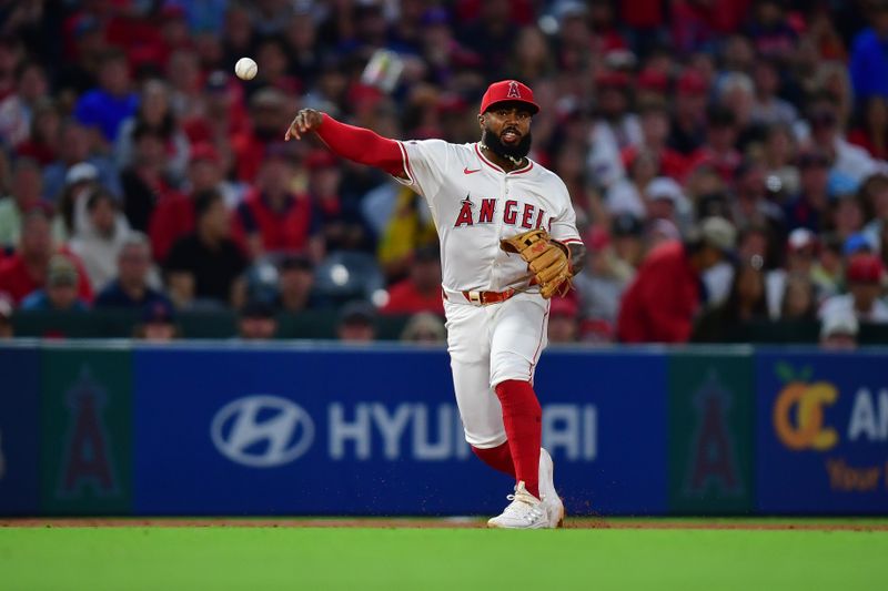 Jun 24, 2025; Anaheim, California, USA; Los Angeles Angels third baseman Luis Rengifo (2) throws to first for the out against Boston Red Sox shortstop Trevor Story (10) during the seventh inning at Angel Stadium. Mandatory Credit: Gary A. Vasquez-Imagn Images