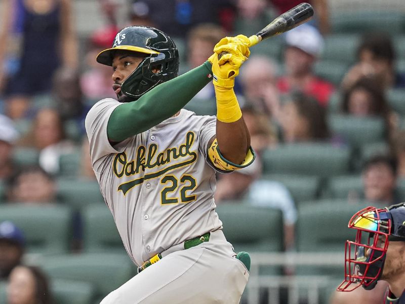 May 31, 2024; Cumberland, Georgia, USA; Oakland Athletics left fielder Miguel Andujar (22) hits a double against the Atlanta Braves during the second inning at Truist Park. Mandatory Credit: Dale Zanine-USA TODAY Sports