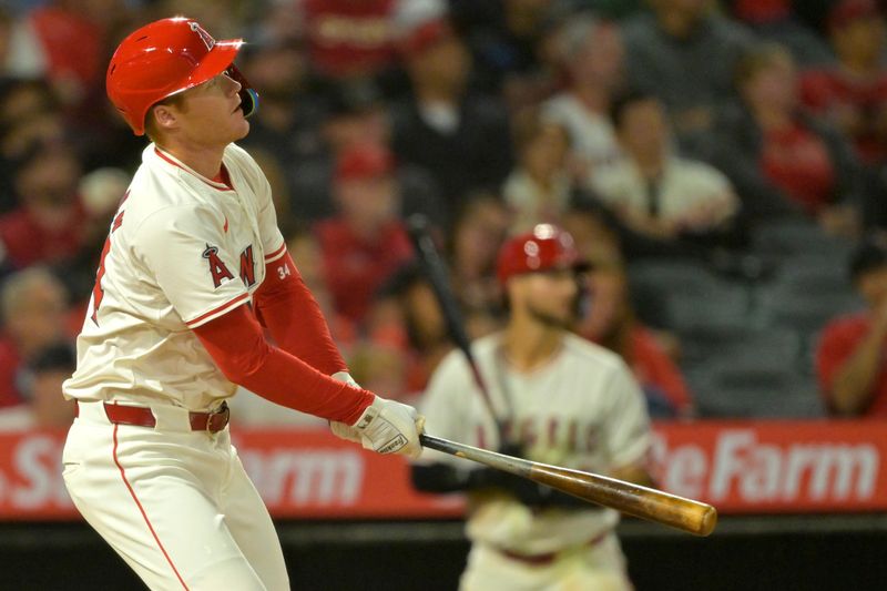 Sep 17, 2024; Anaheim, California, USA;  Los Angeles Angels third baseman Eric Wagaman (34) hits a solo home run in the sixth inning against the Chicago White Sox at Angel Stadium. Mandatory Credit: Jayne Kamin-Oncea-Imagn Images