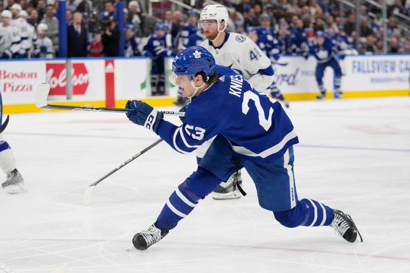 Nov 6, 2023; Toronto, Ontario, CAN; Toronto Maple Leafs forward Matthew Knies (23) shoots the puck against the Tampa Bay Lightning during the third period at Scotiabank Arena. Mandatory Credit: John E. Sokolowski-USA TODAY Sports