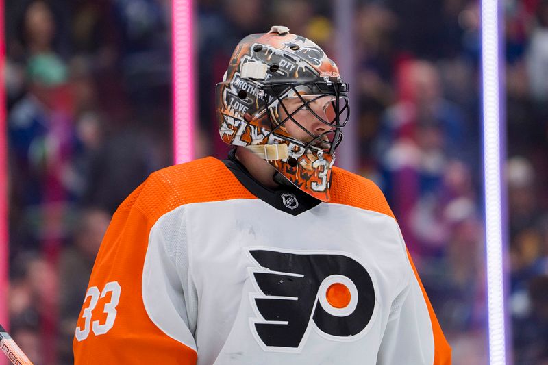 Dec 28, 2023; Vancouver, British Columbia, CAN; Philadelphia Flyers goalie Samuel Ersson (33) during a stop in play against the Vancouver Canucks in the third period at Rogers Arena. Flyers won 4-1. Mandatory Credit: Bob Frid-USA TODAY Sports