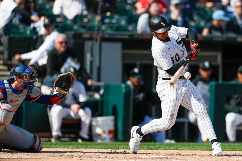 May 24, 2025; Chicago, Illinois, USA; Chicago White Sox second baseman Lenyn Sosa (50) singles against the Texas Rangers during the fourth inning at Rate Field. Mandatory Credit: Kamil Krzaczynski-Imagn Images