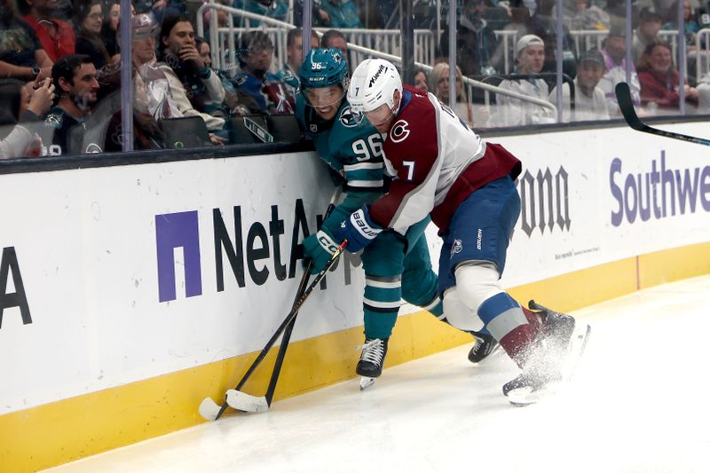 Nov 1, 2025; San Jose, California, USA; San Jose Sharks center Philipp Kurashev (96) and Colorado Avalanche defenseman Devon Toews (7) battle for the puck during the first period at SAP Center at San Jose. Mandatory Credit: Dennis Lee-Imagn Images