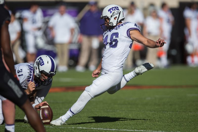 Nov 2, 2019; Stillwater, OK, USA; TCU Horned Frogs place kicker Jonathan Song (46) kicks an extra point from holder Jordy Sandy (31) against the Oklahoma State Cowboys during the second quarter at Boone Pickens Stadium. Mandatory Credit: Brett Rojo-USA TODAY Sports