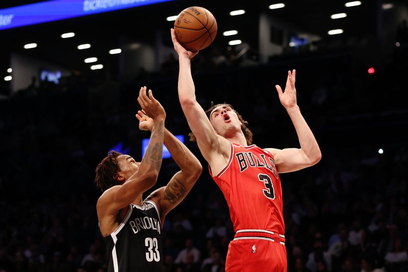 NEW YORK, NEW YORK - NOVEMBER 01: Josh Giddey #3 of the Chicago Bulls goes to the basket as Nic Claxton #33 of the Brooklyn Nets defends during the first half at Barclays Center on November 01, 2024 in the Brooklyn borough of New York City. NOTE TO USER: User expressly acknowledges and agrees that, by downloading and or using this photograph, User is consenting to the terms and conditions of the Getty Images License Agreement. (Photo by Sarah Stier/Getty Images)