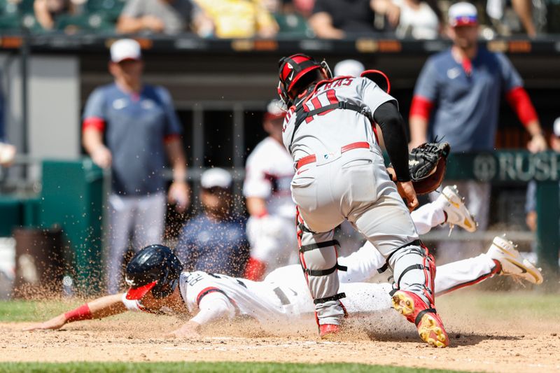 Jul 9, 2023; Chicago, Illinois, USA; Chicago White Sox shortstop Zach Remillard (28) scores against St. Louis Cardinals catcher Willson Contreras (40) during the eight inning at Guaranteed Rate Field. Mandatory Credit: Kamil Krzaczynski-USA TODAY Sports