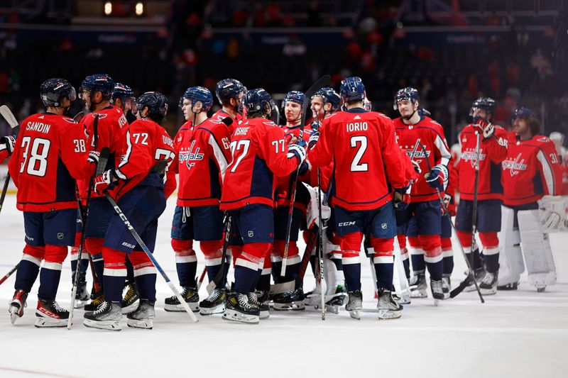 Sep 28, 2023; Washington, District of Columbia, USA; Washington Capitals players celebrate after their game against the Detroit Red Wings at Capital One Arena. Mandatory Credit: Geoff Burke-USA TODAY Sports