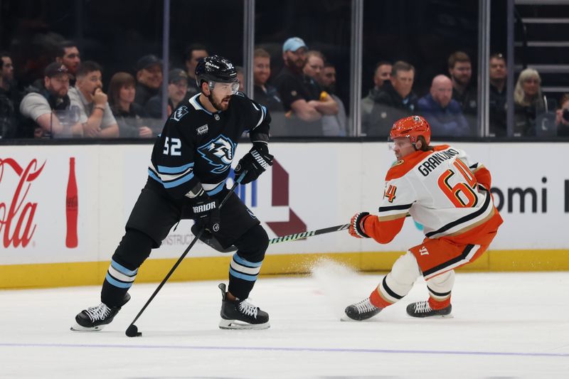 Mar 20, 2026; Salt Lake City, Utah, USA; Utah Mammoth defenseman MacKenzie Weegar (52) looks for a play against Anaheim Ducks center Mikael Granlund (64) during the first period at Delta Center. Mandatory Credit: Rob Gray-Imagn Images