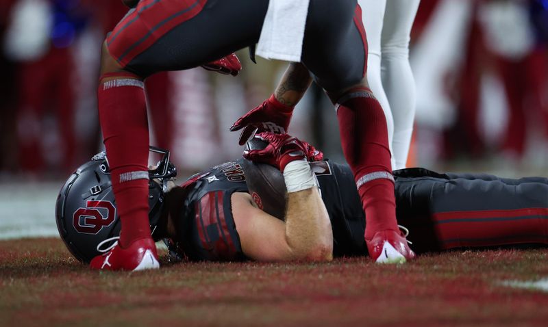 Nov 11, 2023; Norman, Oklahoma, USA; Oklahoma Sooners wide receiver Drake Stoops (12) lays on the ground after catching a touchdown pass during the second half against the West Virginia Mountaineers at Gaylord Family-Oklahoma Memorial Stadium. Mandatory Credit: Kevin Jairaj-USA TODAY Sports