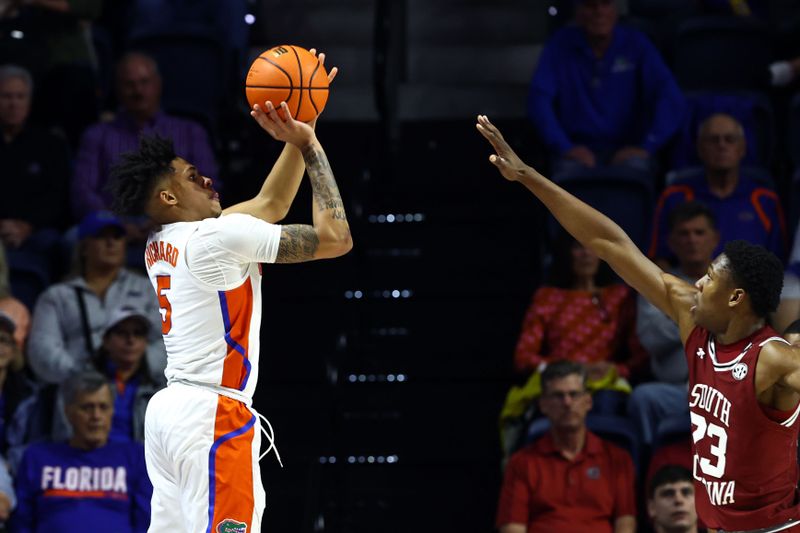 Jan 25, 2023; Gainesville, Florida, USA; Florida Gators guard Will Richard (5) makes a three pointer over South Carolina Gamecocks forward Gregory Jackson II (23) during the first half at Exactech Arena at the Stephen C. O'Connell Center. Mandatory Credit: Kim Klement-USA TODAY Sports