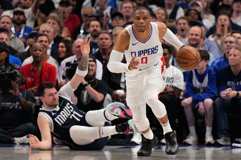 DALLAS, TEXAS - APRIL 26: Russell Westbrook #0 of the Los Angeles Clippers handles the ball in front of Luka Doncic #77 of the Dallas Mavericks during the first half of game three of the Western Conference First Round Playoffs at American Airlines Center on April 26, 2024 in Dallas, Texas. NOTE TO USER: User expressly acknowledges and agrees that, by downloading and or using this photograph, User is consenting to the terms and conditions of the Getty Images License Agreement. (Photo by Sam Hodde/Getty Images)